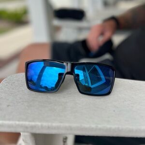 Costa Rincon, black frame with blue glass lens.